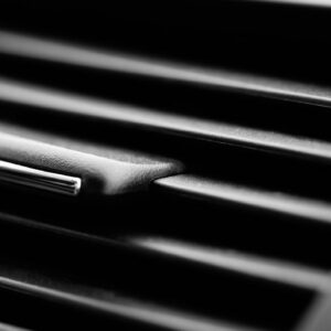 Full frame car interior ventilation detail close-up. Automobile still life closeup detail with selective focus. Vehicle air conditioner still life background, modern car interior and transportation concept.
